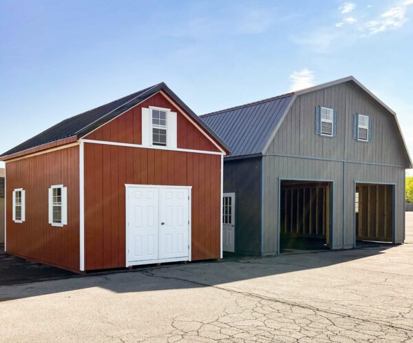 Two-story one-car garage with peak roof and red siding with white trim