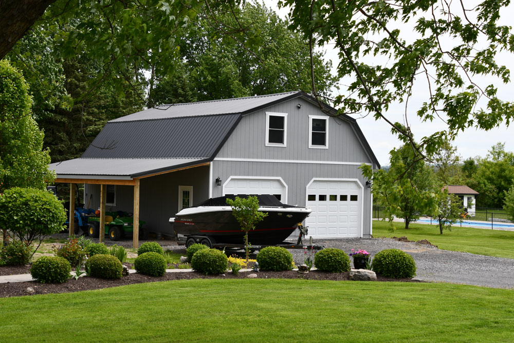 Gablewick garage with lean-to and boat in front
